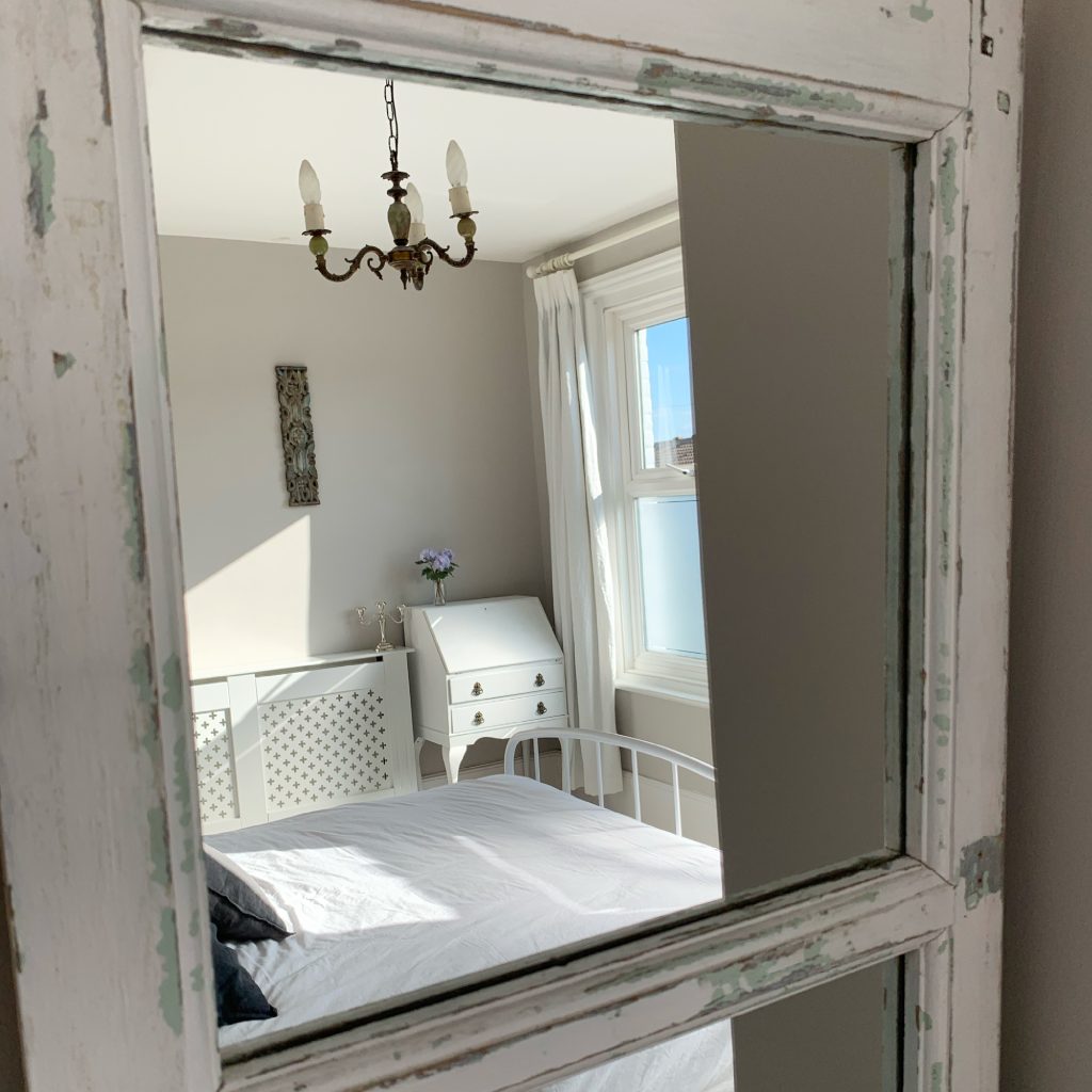picture of a white vintage bureau taken through the reflection of a vintage mirror, taken by The house in Deal