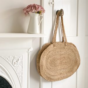 a photo of a straw bag hanging on a door in the bedroom in the house in deal, a holiday cottage for rent in deal kent