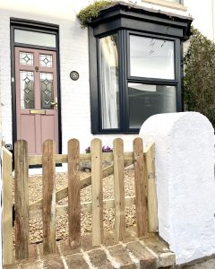Picture of the House in Deal a holiday home in Deal Kent. It shows the wooden front gate, pink front door and bay window. Shot taken by the House in Deal