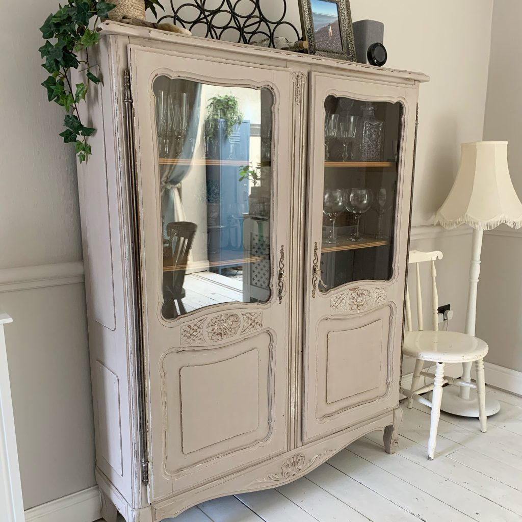 The vintage vitrine containing glasses in the dining room of the house in deal a holiday cottage to rent in Deal kent