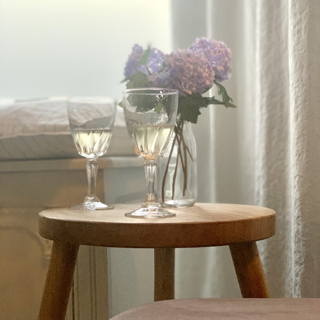 Picture of 2 old fashioned wine glasses on a small table in the sitting room in The House in Deal, holiday cottage to rent in Deal Kent