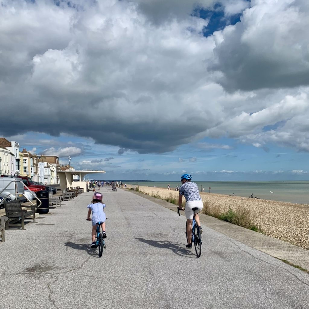 Picture of Deal sea front two cyclists a father and daughter ride along the sea front on their way to The house in Deal