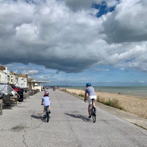 Picture of Deal sea front two cyclists a father and daughter ride along the sea front on their way to The house in Deal