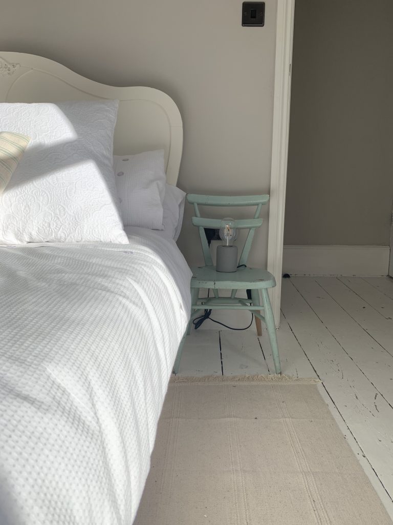 picture of the recoil chair used as a bedside table next the the bed in the house in deal a holiday cottage to rent in deal kent