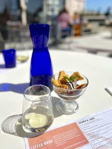 A glass of white wine, a bowl of ice cream and a blue glass water carafe, shot taken by The House in Deal a holiday cottage to rent in Deal Kent