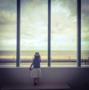 Picture of a little girl standing in front of the windows of the Turner Art Gallery in Margate, shot taken by The house in deal a holiday cottage to rent in deal kent
