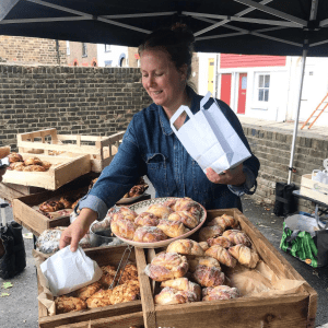 picture of a stall holder serving from a market stall