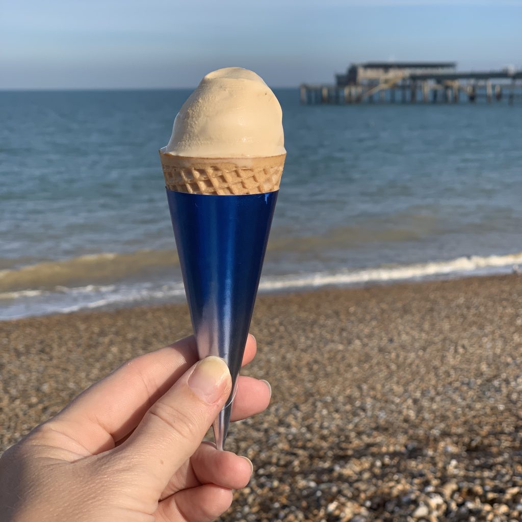 february half term in deal kent a picture of a hand holiday an icecream in the background is deal pier and the sea