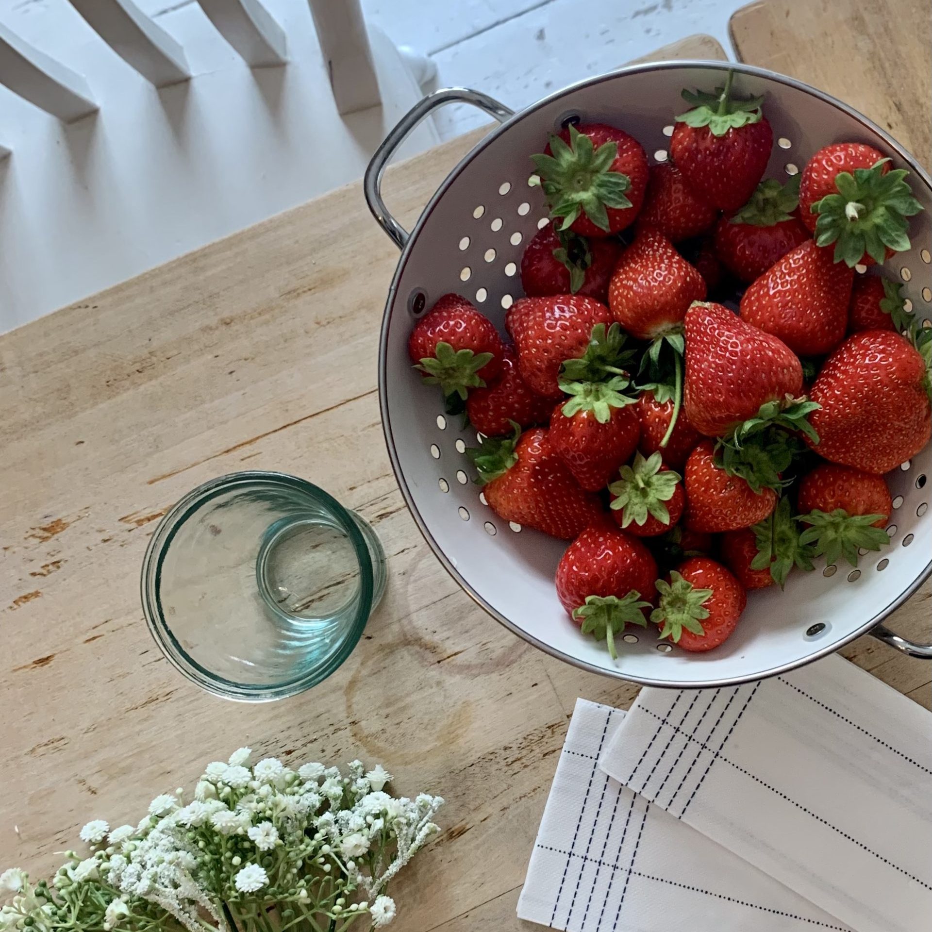 strawberries in a white colander